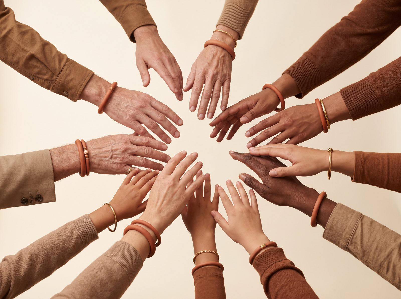 Hands of people of different ages reaching together